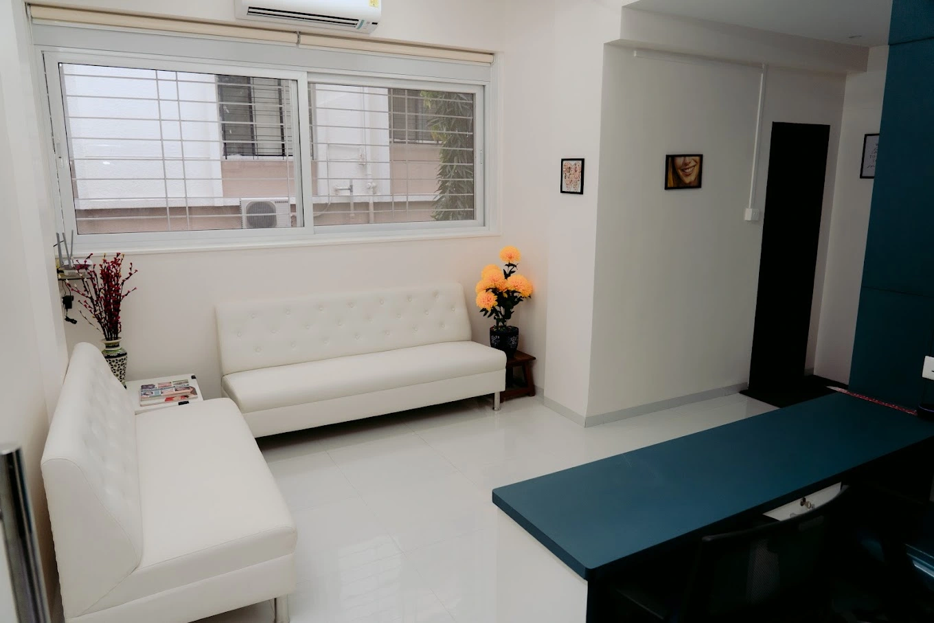 Modern and well-lit dental clinic interior with comfortable seating and a clean design