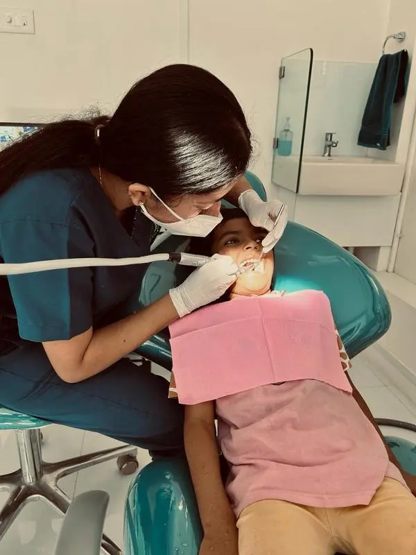 A dentist performing a treatment with modern dental tools and equipment